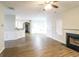 Spacious living room with wood floors, a fireplace, and a seamless transition to the dining area at 139 Surge Stone Ln, Stockbridge, GA 30281