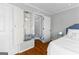 Cozy bedroom has an open ironing board cabinet and white and gray walls at 679 Bo Bo Banks Rd, Grantville, GA 30220