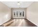 Living room with beautiful floor and French doors to the backyard at 679 Bo Bo Banks Rd, Grantville, GA 30220