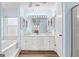 Bright main bathroom features white cabinets, double sinks, modern fixtures, with a separate tub and shower at 679 Bo Bo Banks Rd, Grantville, GA 30220