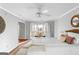 Bright main bedroom with access to a sunroom, features a ceiling fan and lots of light at 679 Bo Bo Banks Rd, Grantville, GA 30220