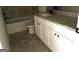 Neutral bathroom featuring a tub and shower, as well as a vanity with white cabinets and a granite countertop at 413 Samara Ct, Fairburn, GA 30213