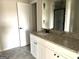 Neutral bathroom featuring a large mirror, white cabinets, granite countertops, and new fixtures at 413 Samara Ct, Fairburn, GA 30213
