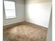 Carpeted bedroom includes one window for natural light at 413 Samara Ct, Fairburn, GA 30213