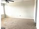 Spacious carpeted bedroom featuring a ceiling fan and two bright windows providing natural light at 413 Samara Ct, Fairburn, GA 30213
