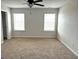 Spacious bedroom with plush carpeting, filled with natural light from the large windows at 413 Samara Ct, Fairburn, GA 30213