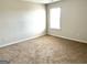 Bedroom features plush carpeting, a window for natural light and neutral paint at 413 Samara Ct, Fairburn, GA 30213