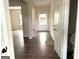 View of entryway with dark wood flooring and white front door at 413 Samara Ct, Fairburn, GA 30213