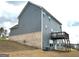Rear view of a two-story home with a wooden deck at 413 Samara Ct, Fairburn, GA 30213