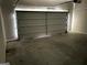 Spacious garage with concrete floors and large white garage door at 413 Samara Ct, Fairburn, GA 30213