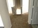 Hallway with neutral walls and plush carpet leading up to the second floor at 413 Samara Ct, Fairburn, GA 30213