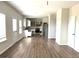 Open floor plan with hardwood floors and a modern kitchen view at 413 Samara Ct, Fairburn, GA 30213