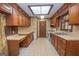 Spacious kitchen with ample wood cabinets, linoleum floors, and a skylight providing natural light at 165 N Mourning Dove Dr, Fayetteville, GA 30215