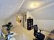 Carpeted attic with exercise bike, desk and chair at 170 White Rd, Fayetteville, GA 30214