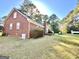 Large backyard with a brick home, showcasing a functional outdoor space with mature trees and well-maintained landscaping at 170 White Rd, Fayetteville, GA 30214