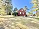 Grassy backyard featuring a brick home with white-trimmed windows, providing a serene and private outdoor space at 170 White Rd, Fayetteville, GA 30214