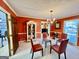 Elegant dining room featuring a glass table, leather chairs, and a decorative chandelier, ideal for formal dining experiences at 170 White Rd, Fayetteville, GA 30214