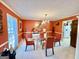 Vibrant dining room with orange walls, a glass table, and modern chairs, perfect for memorable gatherings and meals at 170 White Rd, Fayetteville, GA 30214
