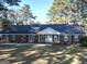 Charming brick home with a manicured lawn and mature trees, offering classic curb appeal and a welcoming entrance at 170 White Rd, Fayetteville, GA 30214