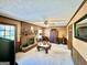 Cozy living room features a brick fireplace, ceiling fan, and traditional decor at 170 White Rd, Fayetteville, GA 30214