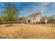 Spacious backyard featuring a patio set with a table and chairs, surrounded by a dark metal fence at 305 Roundwood Way, Peachtree City, GA 30269