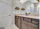 Bathroom with granite countertops, double vanity and dark wood cabinets at 305 Roundwood Way, Peachtree City, GA 30269