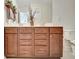 Bathroom vanity with wooden cabinets and double sinks, next to a toilet at 305 Roundwood Way, Peachtree City, GA 30269