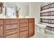 Bathroom vanity with wooden cabinets and double sinks, next to a toilet and shower at 305 Roundwood Way, Peachtree City, GA 30269