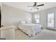 Bright bedroom with carpet, ceiling fan, dresser, and door to balcony at 305 Roundwood Way, Peachtree City, GA 30269
