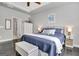 A well lit bedroom with a bed, side tables and a storage cabinet, great for relaxing at 305 Roundwood Way, Peachtree City, GA 30269