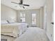 Bright bedroom with carpet, ceiling fan, and door to balcony at 305 Roundwood Way, Peachtree City, GA 30269
