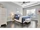 A bedroom with a bed, ceiling fan, and closet with lots of natural light at 305 Roundwood Way, Peachtree City, GA 30269