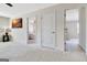 Bright bedroom with carpeted floors and a door to another room at 305 Roundwood Way, Peachtree City, GA 30269
