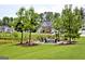 Community firepit area with chairs, pond, and manicured lawn at 305 Roundwood Way, Peachtree City, GA 30269