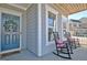 Charming front porch with rocking chairs and a stylish door at 305 Roundwood Way, Peachtree City, GA 30269