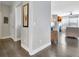 Inviting hallway with access to laundry, dining area, and living room featuring a fireplace at 305 Roundwood Way, Peachtree City, GA 30269