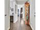 Inviting hallway view showcases hardwood floors and decorative cabinet with views into adjacent rooms at 305 Roundwood Way, Peachtree City, GA 30269