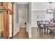 Bright hallway view with dining room, hardwood floors, wainscoting, and a half bath at 305 Roundwood Way, Peachtree City, GA 30269