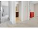 Hallway with carpet and white trim leading to the bedroom and bathroom at 305 Roundwood Way, Peachtree City, GA 30269