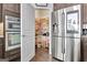 Kitchen pantry door opened showing ample shelving space, next to stainless steel refrigerator at 305 Roundwood Way, Peachtree City, GA 30269