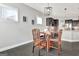 A cozy breakfast nook with modern lighting and dark wood flooring adjacent to kitchen with granite countertop peninsula at 305 Roundwood Way, Peachtree City, GA 30269