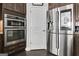 Modern kitchen with stainless steel refrigerator, microwave oven and dark wood cabinets at 305 Roundwood Way, Peachtree City, GA 30269