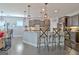 Open concept kitchen features a large island with bar seating, stainless appliances and modern lighting at 305 Roundwood Way, Peachtree City, GA 30269