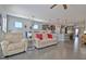 Open living space with a comfortable sofa, adjacent to the kitchen, with stainless steel appliances at 305 Roundwood Way, Peachtree City, GA 30269