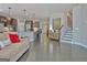 Living room with a view of the kitchen with a breakfast bar and staircase to upper level at 305 Roundwood Way, Peachtree City, GA 30269