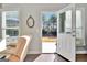 Patio door with view of the backyard, chair and clock shown in the room with sunlight beaming in at 305 Roundwood Way, Peachtree City, GA 30269