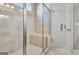 Shower with glass doors, a bench, and tile walls in the bathroom at 305 Roundwood Way, Peachtree City, GA 30269
