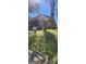 Exterior shot of a brick home with a screened porch; the yard needs a bit of maintenance at 586 Glen Iris Ne Dr, Atlanta, GA 30308