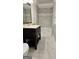 Bathroom featuring a black vanity with stone countertop, tile floors and walk-in shower at 3189 Fern Ridge Ne Dr, Conyers, GA 30013