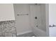 Bathroom featuring modern tub and tile accent at 3189 Fern Ridge Ne Dr, Conyers, GA 30013